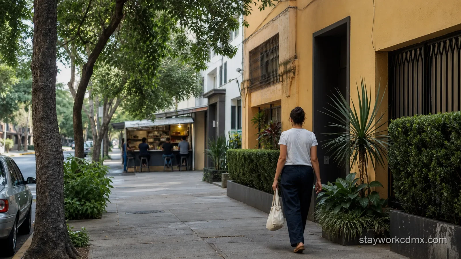 A resident walks along a leafy Narvarte street from a neighborhood lunch stop toward a furnished long-stay apartment.