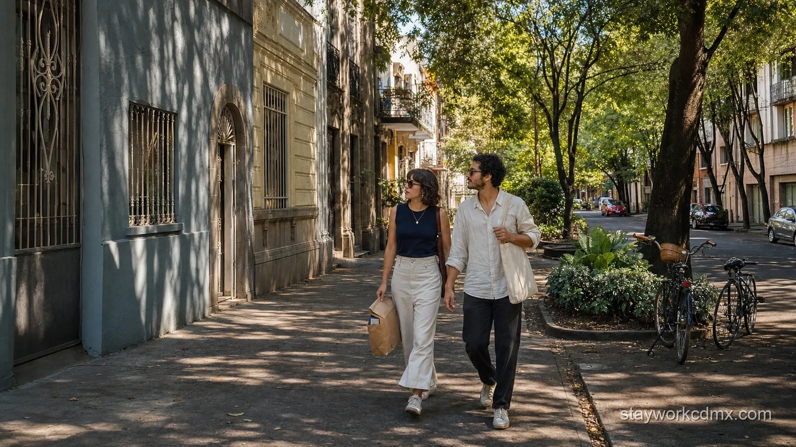 Two friends take an unhurried shaded walk through Roma Norte with a bakery bag between popular food stops.