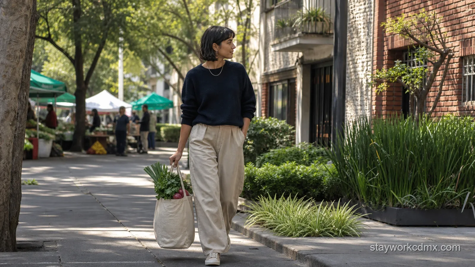 A shopper carries a light tote of fresh produce home from a Sunday market along a leafy Roma Sur sidewalk.