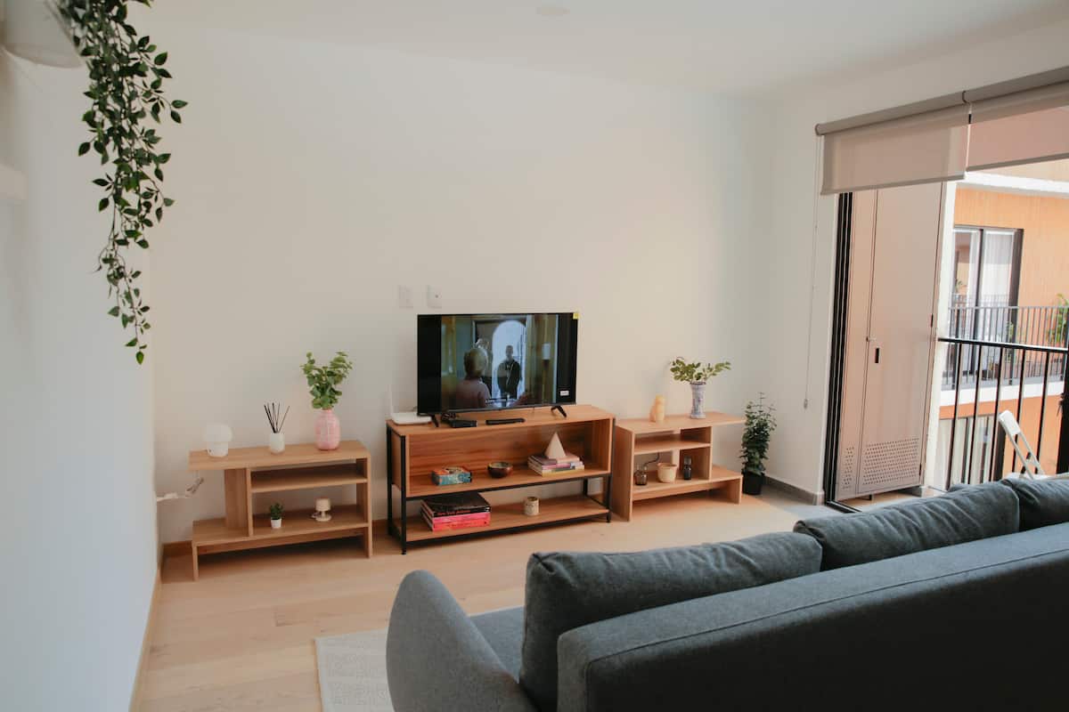 Bright Roma Norte loft living room with balcony light
